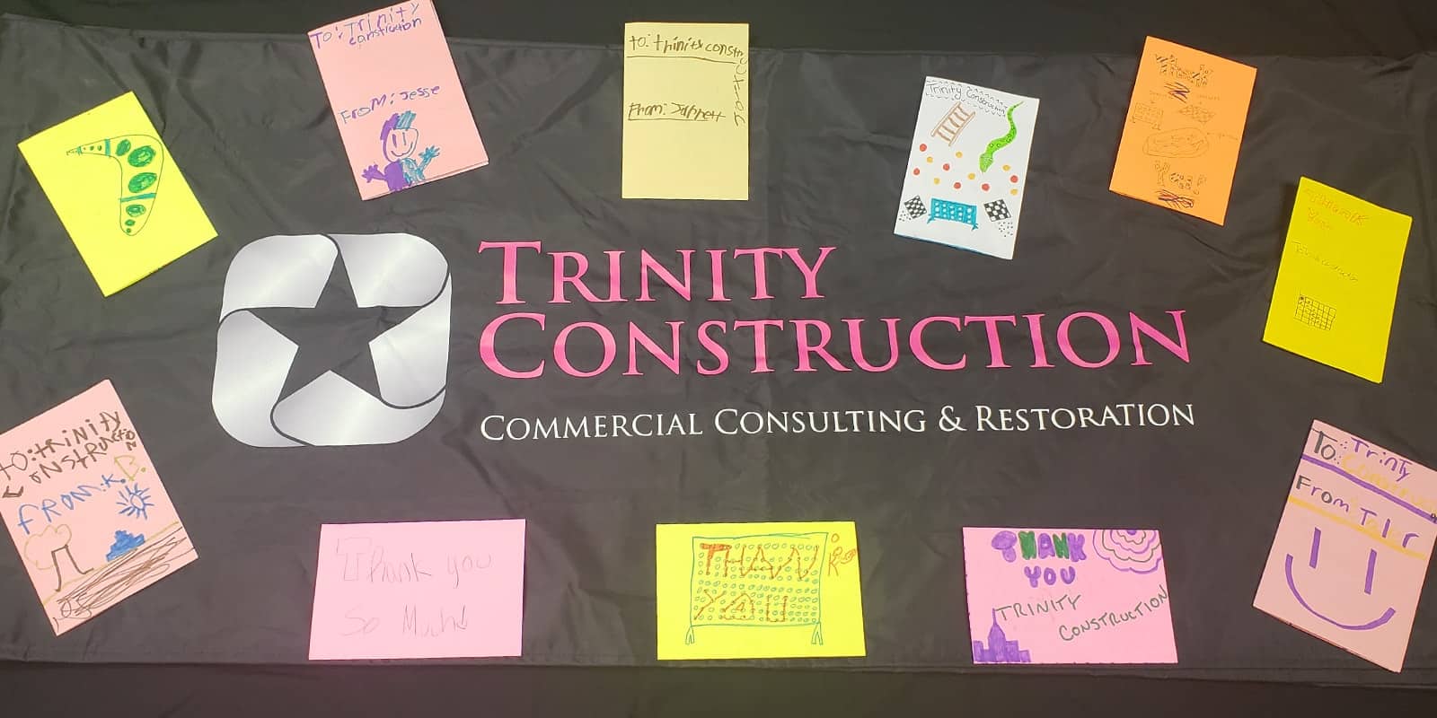 Thank you cards made by kids on a Trinity Construction commercial Consulting and restoration banner